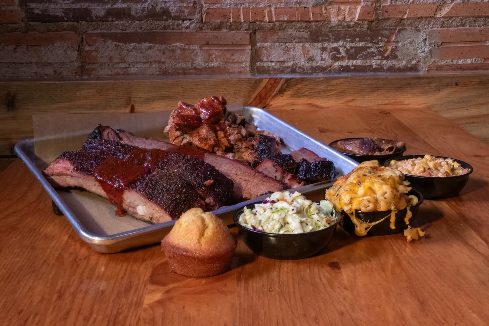 A tray of ribs, brisket, mac and cheese, slaw and cornbread
